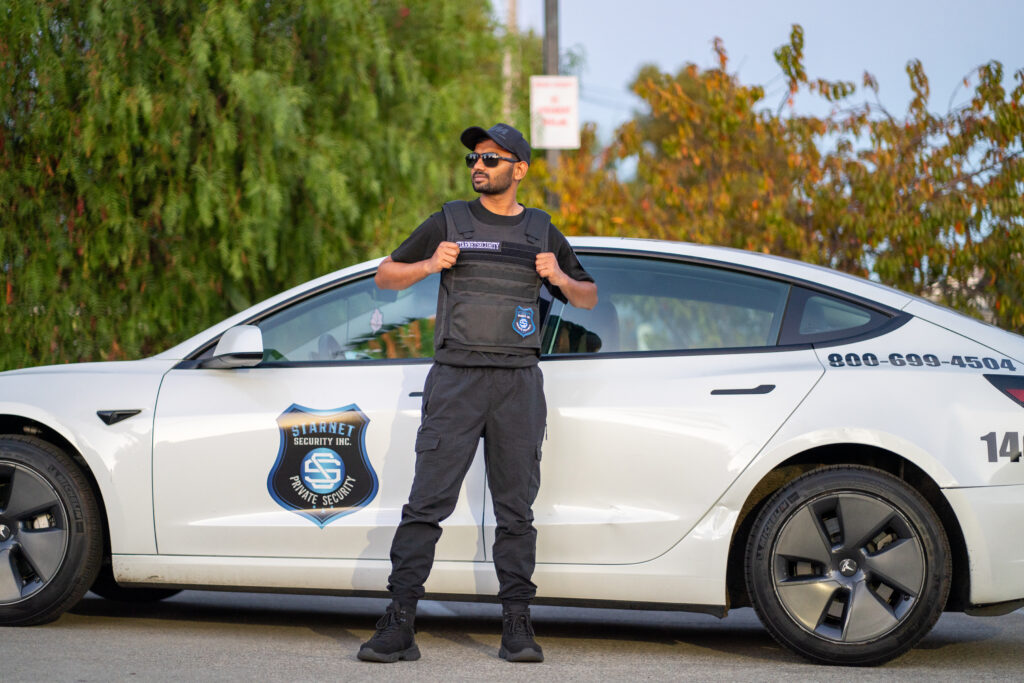 starnet security guard stands in front of mobile patrol car